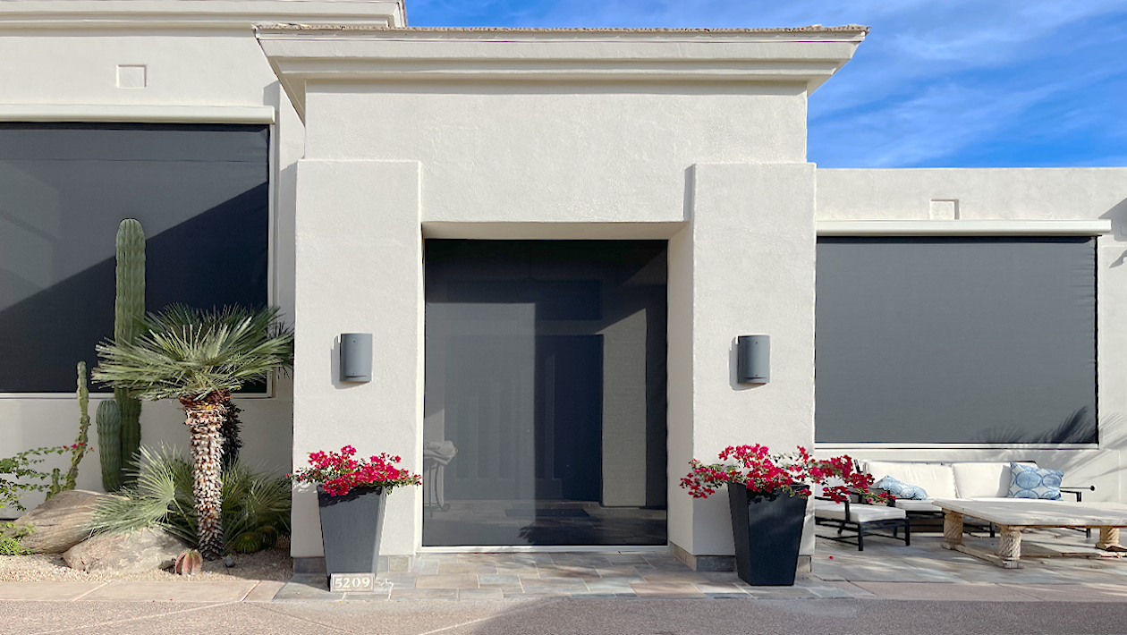 a white building located in San Diego with Vanishing Screens motorized patio shades and motorized outdoor sun screens installed on the home.